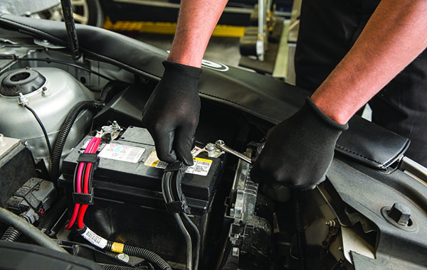 hands on a car battery